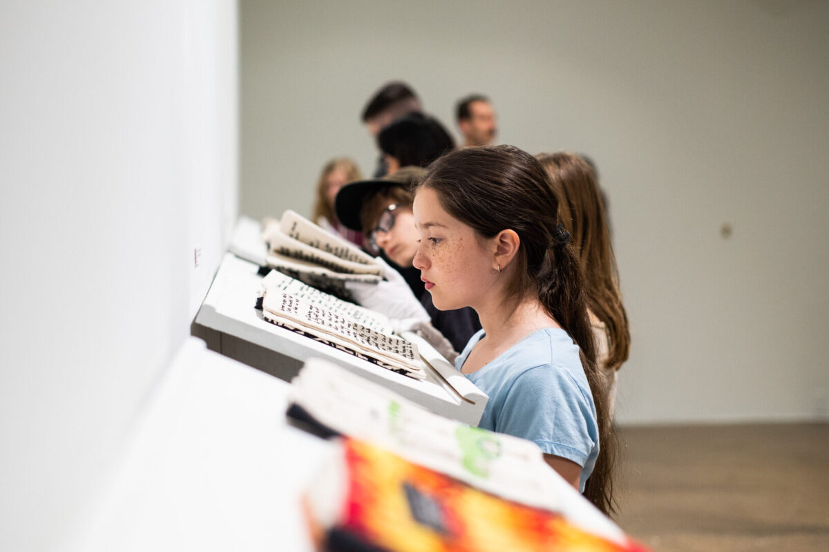 Children reading books made out of fabric.